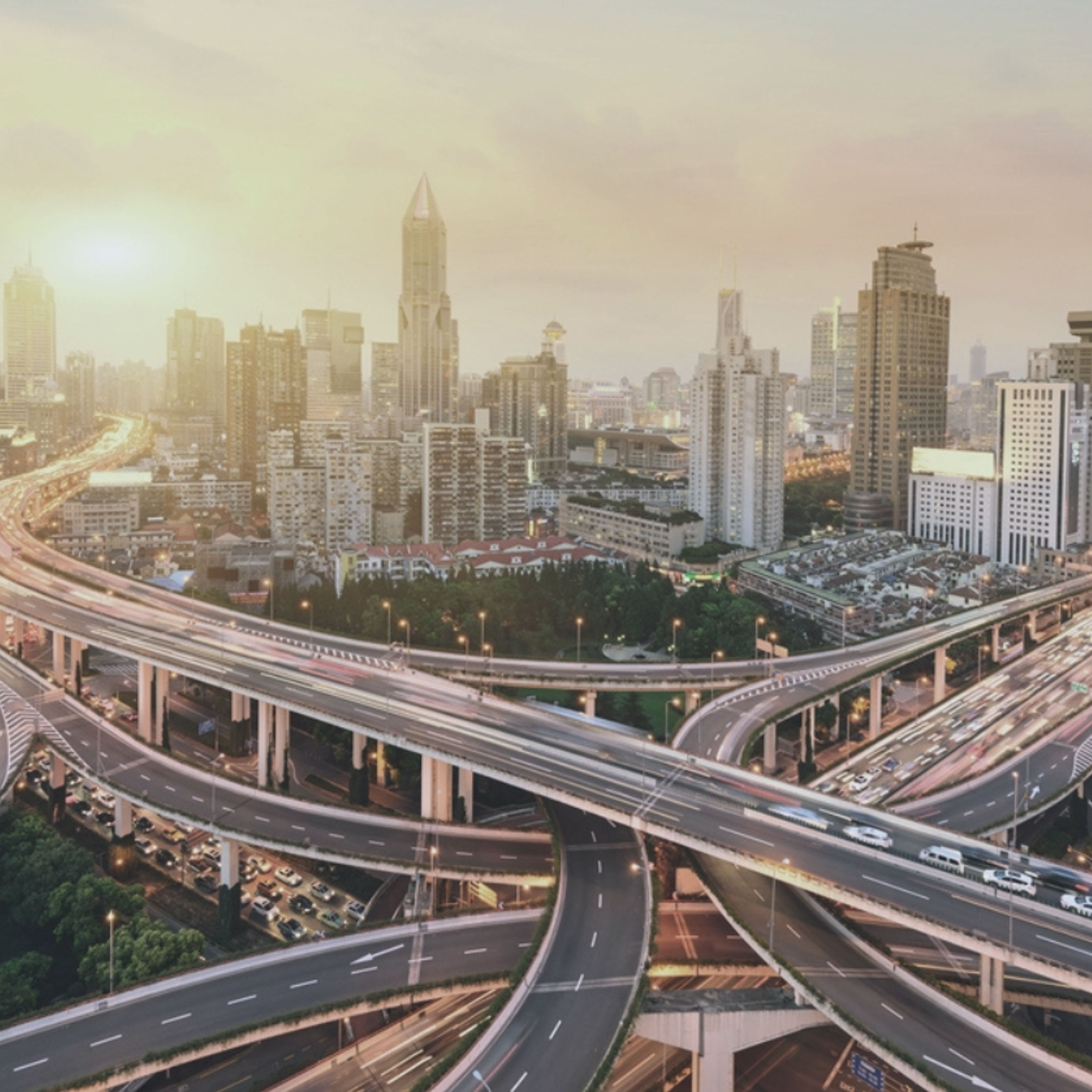 A bird's-eye view of a busy city with a complex highway network.