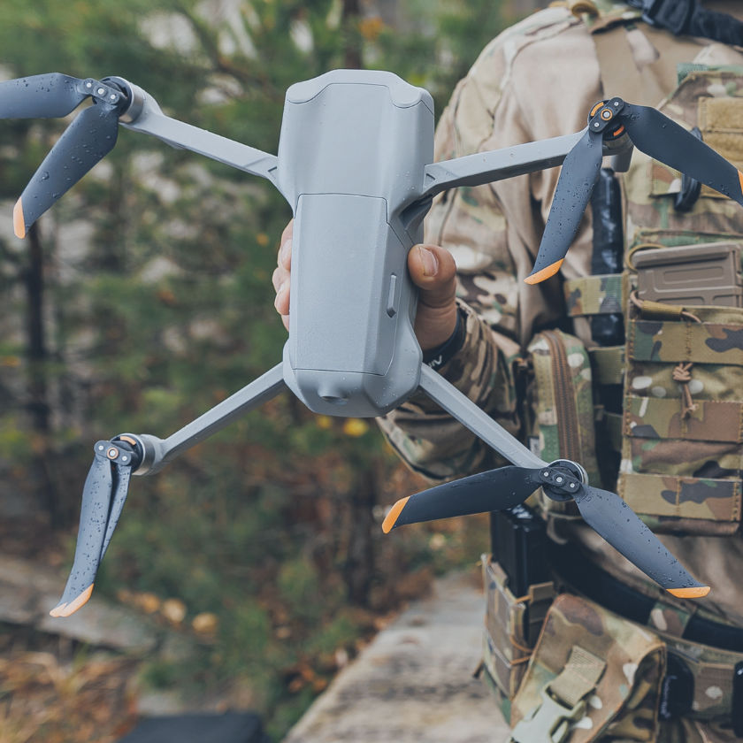 Military use of aerial drones in the army. A soldier engineer holds an automatic quadrocopter in his hands.