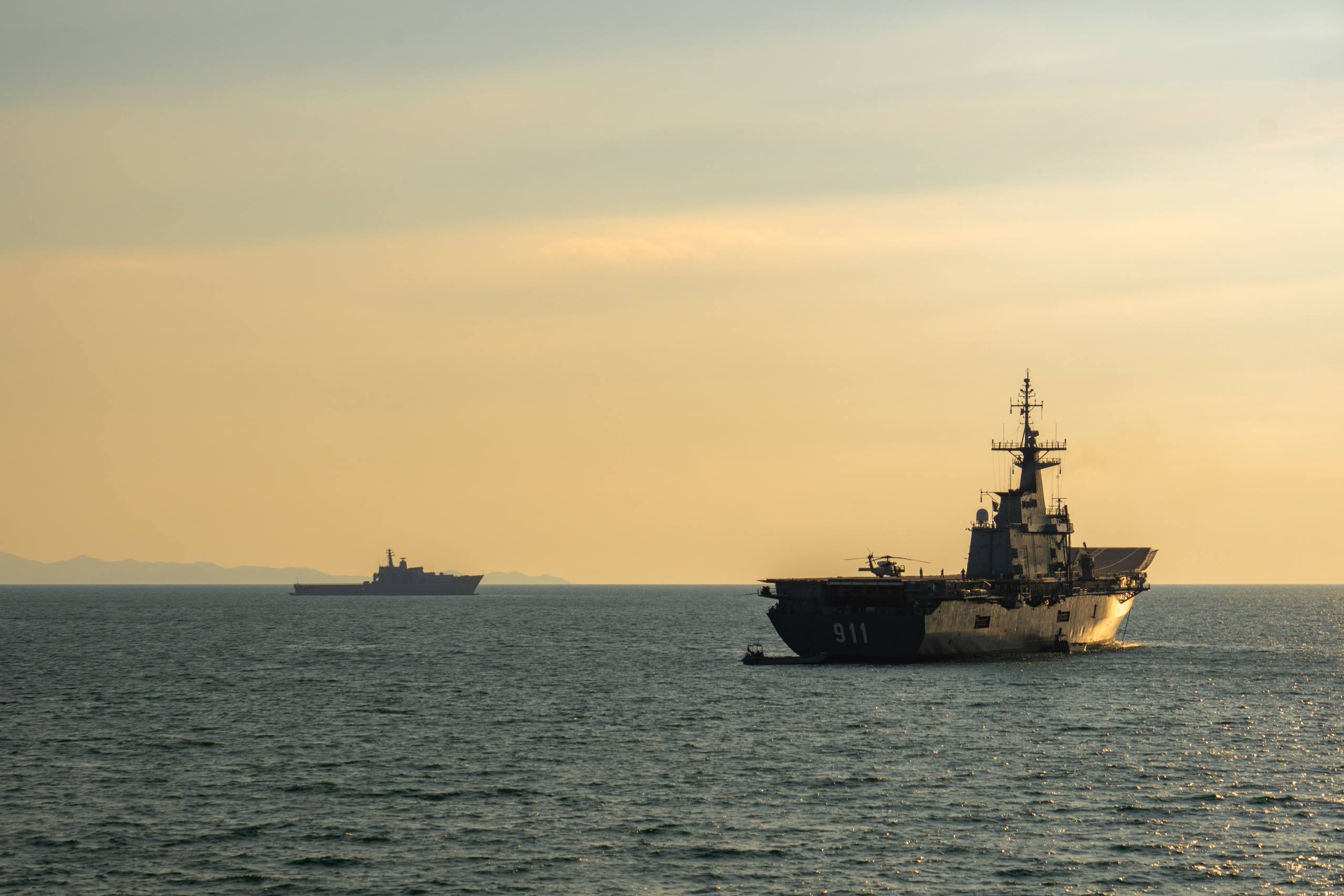 PHUKET, THAILAND - APRIL 9, 2019: HTMS Chakri Naruebet (CVH-911) Aircraft carrier HTMS Angthong (LPD 791) of Royal Thai navy anchors at Andaman Sea near Phuket.