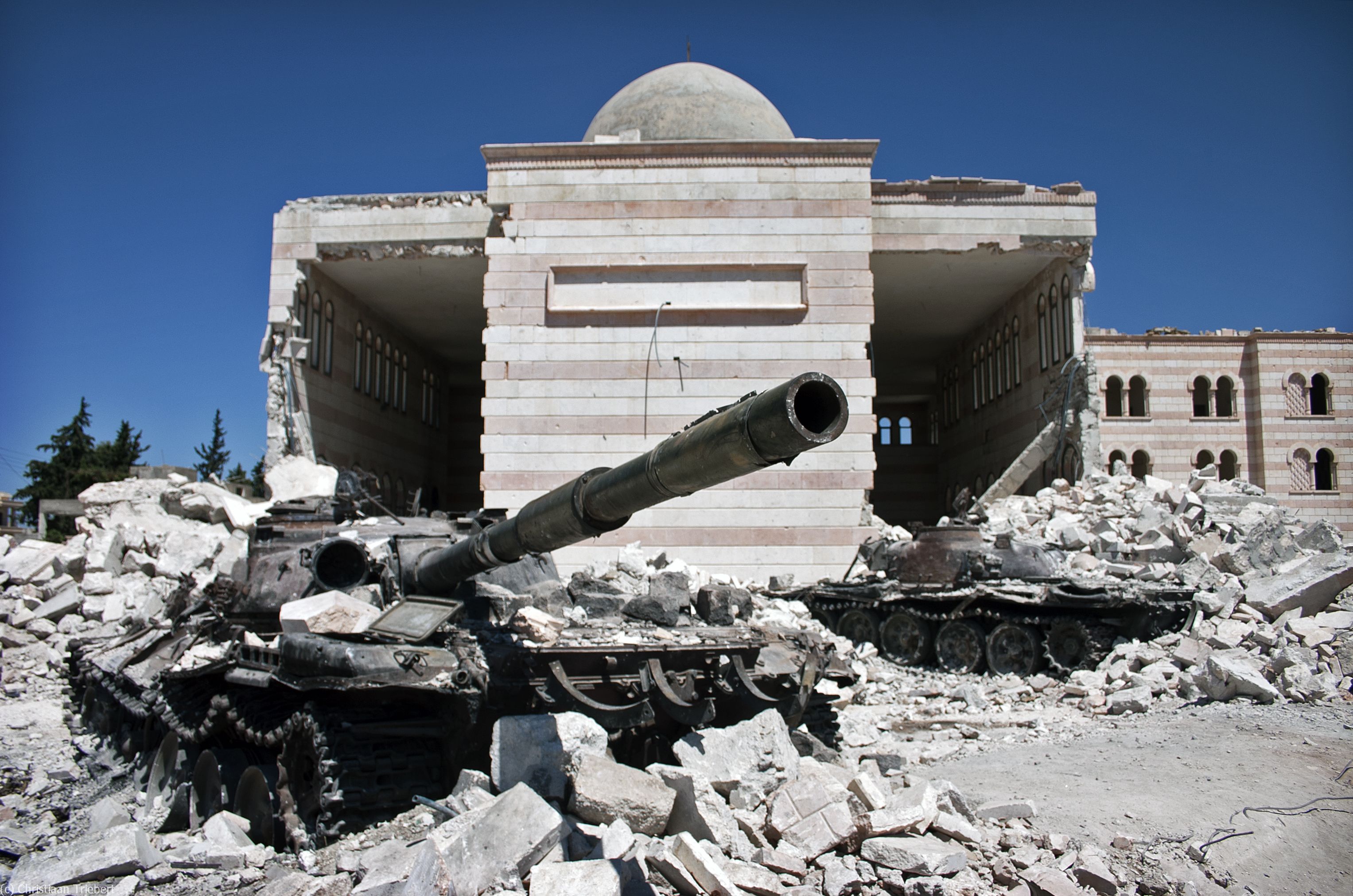 Two destroyed tanks in front of a mosque in Azaz, Syria, 2012.