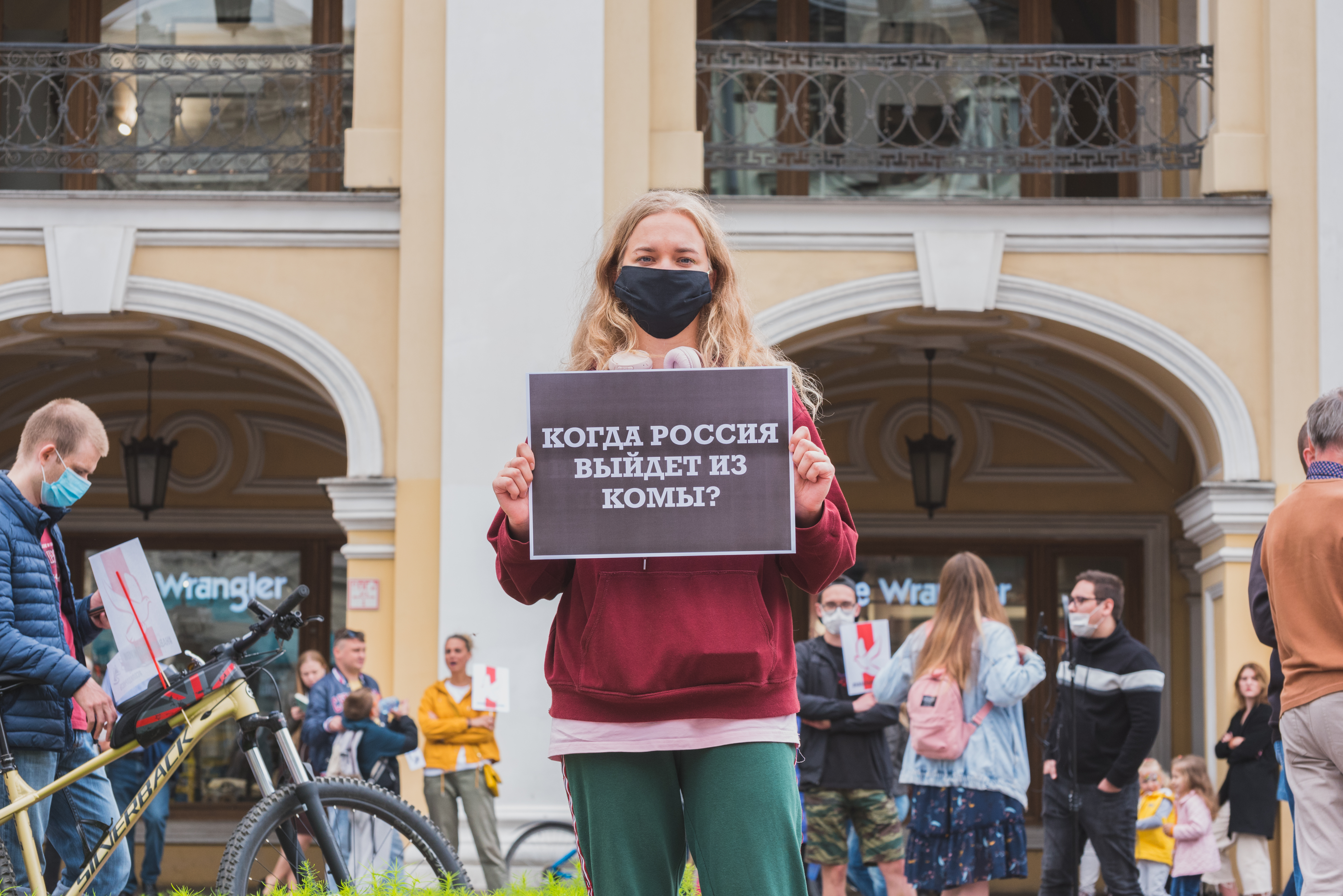 Saint Petersburg, August 2020: a protester holds a poster "When will Russia come out of coma?" at a rally.