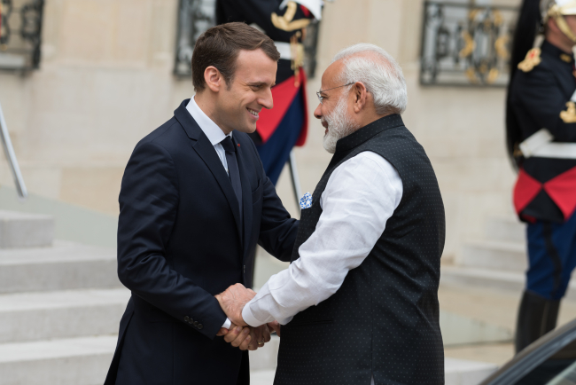 The President of France, Emmanuel Macron welcoming the Prime Minister of India, Narendra Modi.