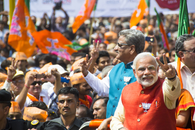 VADODARA, GUJARAT/INDIA - 9 April 2014 :Gujarat Chief Minister and BJP prime ministerial candidate Narendra Modi showing victory sign on 9th april in Vadodara, Gujarat.