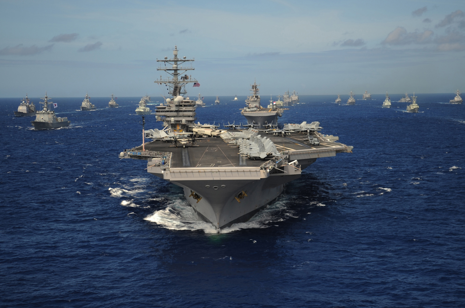 Aircraft carrier USS Ronald Reagan leads a formation of allied ships from through the Pacific Ocean